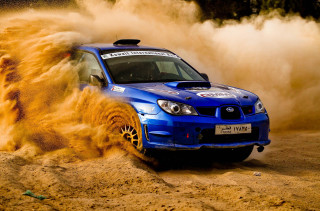 Blue car driving sandy area - dust free wallpaper