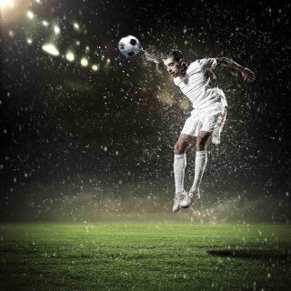 Soccer player jumping kick ball - night time free wallpaper