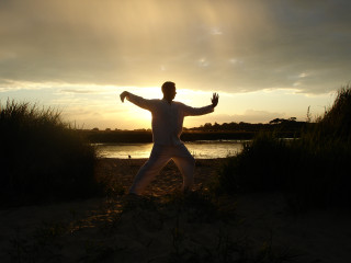 Man beach arms outstretched sunset - fabien charuau free wallpaper