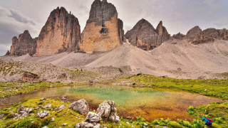 Mountain lake rocks grass people - the other side of the lake free wallpaper