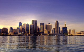 City skyline water boat background - a boat in the foreground free wallpaper