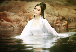 Woman white dress water rocks - a waterfall in the background free wallpaper