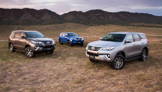 Suvs parked field mountains cloudy - private press free wallpaper