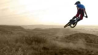 Man flying bike dirt road 2 - widescreen free wallpaper