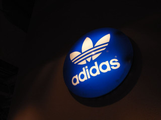 Blue adidas sign building night - the side of a building free wallpaper