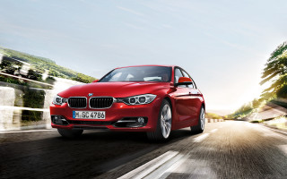 Red car driving road forest - constant permeke free wallpaper