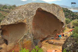 Large rock climbers mountains lake - a large rock free wallpaper