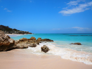 Beach rock formation blue water 3 - a few wave free wallpaper
