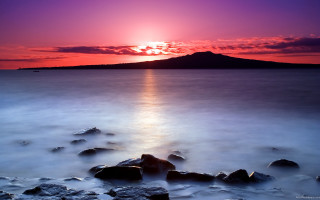Sunset water rocks mountain orange - orange sun free wallpaper