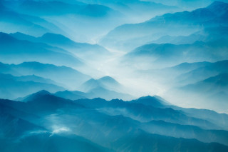 Mountain range plane window sunset 3 - a view of a mountain range free wallpaper