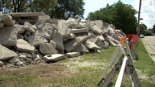 Pile of rocks next to - a bench in front free wallpaper