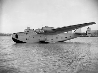 Airplane floating water shoreline buildings - carl walter liner free wallpaper