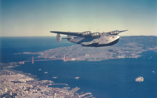 Airplane flying water bridge city - a city below free wallpaper