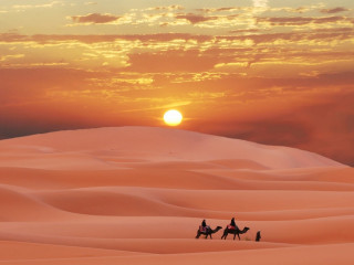 People riding sandy hill sunset - a camel free wallpaper