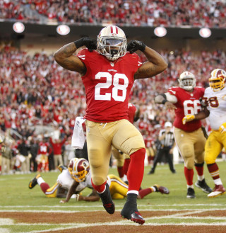 Football player running field helmet - free sports wallpaper