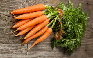 Carrots wooden surface green leaves - top of them free wallpaper