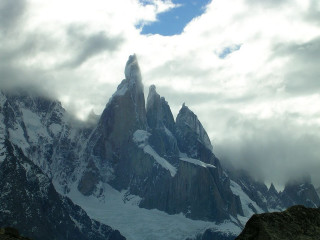 Snowy mountain clouds rocks ground - a few rock below free wallpaper