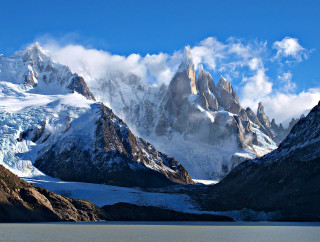 Mountain snow clouds water sky - a body of water below free wallpaper