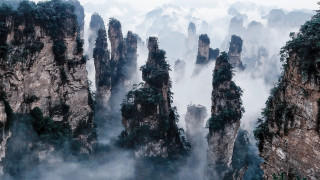 Mountain landscape rocks trees foggy - a mountain landscape free wallpaper