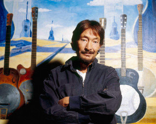 Man standing painting guitars arms - cliff childs free wallpaper