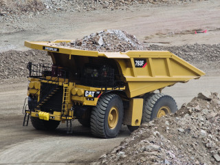 Dump truck dumping rocks desert - a dirt road in the desert free wallpaper