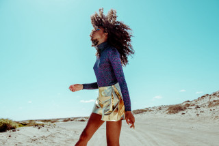 Woman blue top gold skirt - a dirt road in the desert free wallpaper