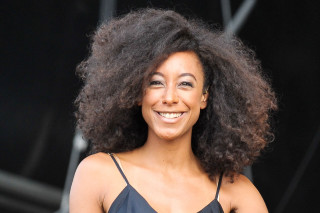 Woman afro smiling stage microphone - a photo free wallpaper