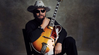 Cowboy hat sunglasses guitar pose - a guitar free wallpaper