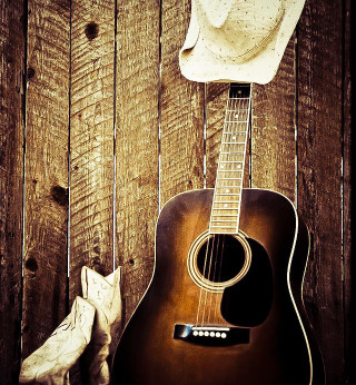 Cowboy hat guitar wooden wall - a stock photo free wallpaper