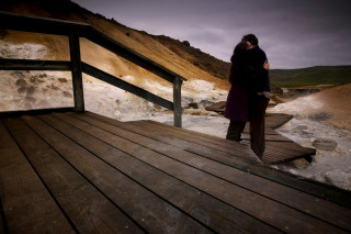 Woman standing wooden deck river - soft free wallpaper