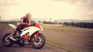 Woman motorcycle road field fence - a plane in the background free wallpaper