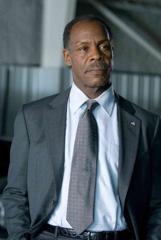 Man in suit building cobra - his hands in his pockets free wallpaper