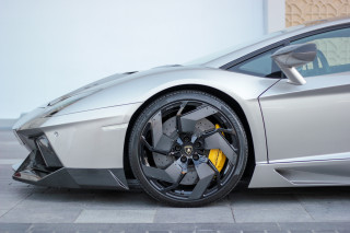 Silver sports car yellow stripe 2 - a white wall behind free wallpaper