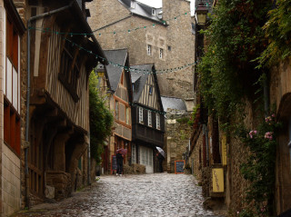 Cobblestone street clock tower person - romanesque free wallpaper