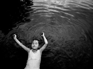 Young girl floating water frisbee - the water free wallpaper