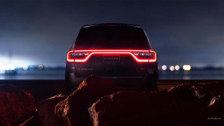 Car parked rocky beach night - ambient lighting free wallpaper