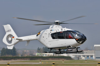 Helicopter flying low field building - low free wallpaper