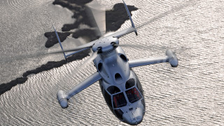 Small white helicopter flying water - over a body of water free wallpaper