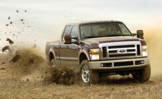 Truck driving field dirt grass - overhead free wallpaper