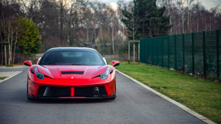 Red sports car driving road 3 - a fence and trees free wallpaper