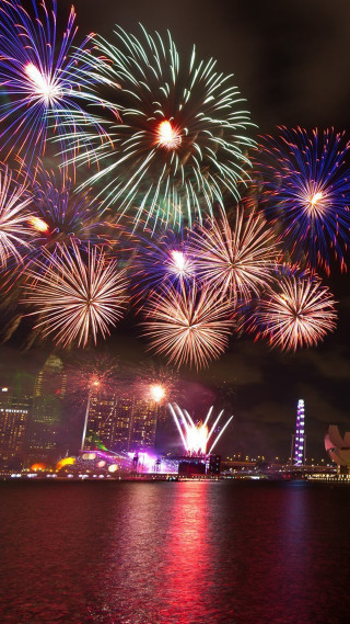 Fireworks city night reflections skyline - free new year wallpaper