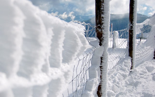 Fence covered snow piled mountain - a fence free wallpaper