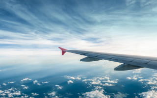 Plane wing sky clouds water 2 - a view of the wing free wallpaper