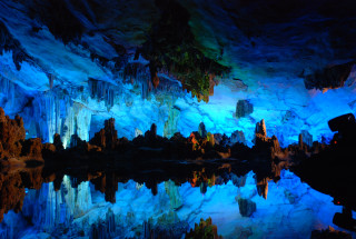 Cave lake blue reflection trees - the water and a mountain in the background free wallpaper