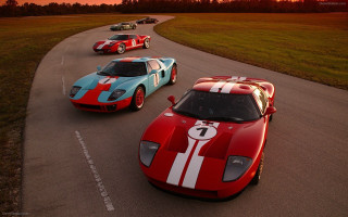 Race cars sunset dawn road - the sun setting behind them free wallpaper
