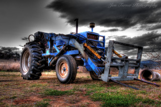 Blue tractor parked field storm - allen tupper true free wallpaper
