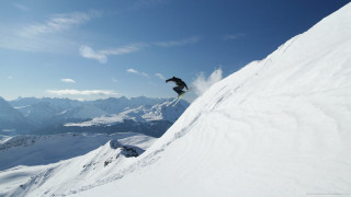 Snowboarder jumping snowy hill mountains - a snowboard free wallpaper