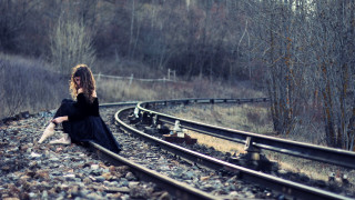 Woman sitting train track cell - a train track free wallpaper