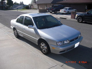 Silver car parked street sidewalk - front view free wallpaper