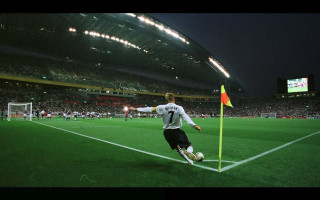 Soccer player kicking night stadium - full free wallpaper